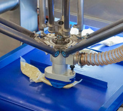 Bags of sauce emerge from a vision system and are picked up by a robotic gripper